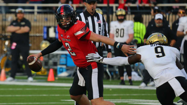 Texas Tech Red Raiders quarterback Behren Morton (2) is pressured by Central Florida Knights defensive safety Jireh Wilson (9) in the first half at Jones AT&T Stadium and Cody Campbell Field.